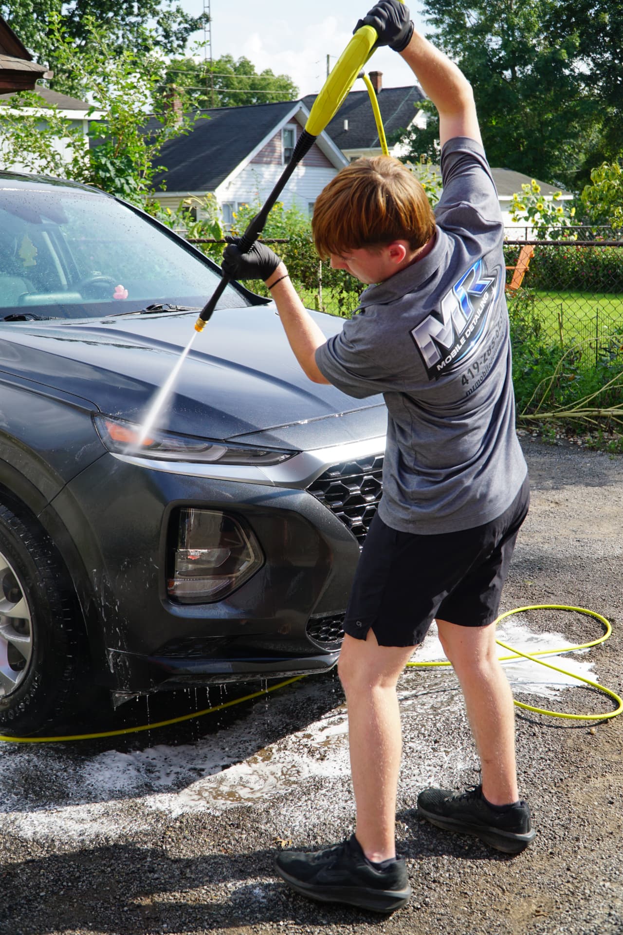 MR Mobile Detailing team member pressure-washing an SUV in Ashland, Ohio